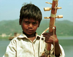 Boy plays self-made violin.